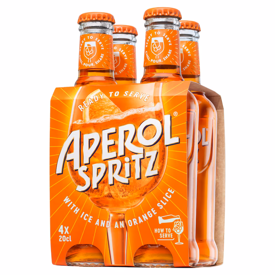 Summer starts here Four-pack of Aperol Spritz 200ml bottles in orange cardboard packaging, featuring bold white and yellow text, branding, and serving instructions with an illustrated glass and orange slice on the front. The bottles have orange caps and are visible through the packaging—perfect for when summer starts or any vibrant summer gathering.